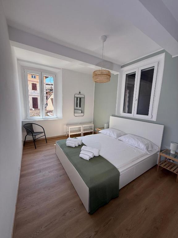 a bedroom with a large bed with two towels on it at La Filanda Apartment in Castelvetro di Modena