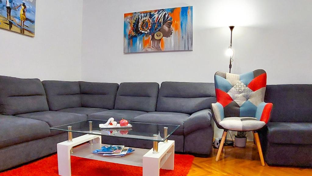 a living room with a couch and a chair at Mendys Sea View - Pomalo & Fjaka Retreat in Kaštela