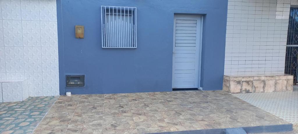 a blue door with a window on a building at Casa de Lagoa Nova in Martins