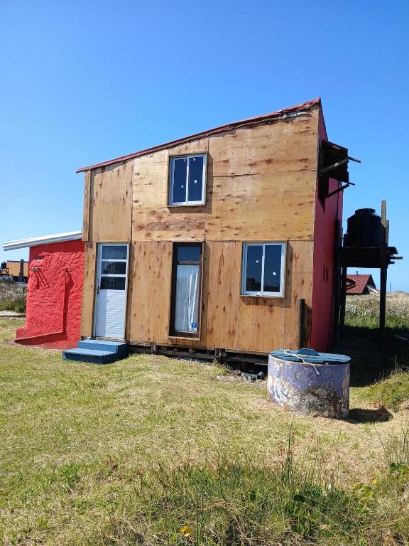 a house that is sitting on top of a field at El Rancho de Marcela in Cabo Polonio