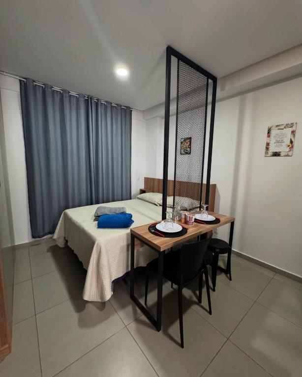 a bedroom with a bed and a table with a mirror at JR west fit in Mossoró