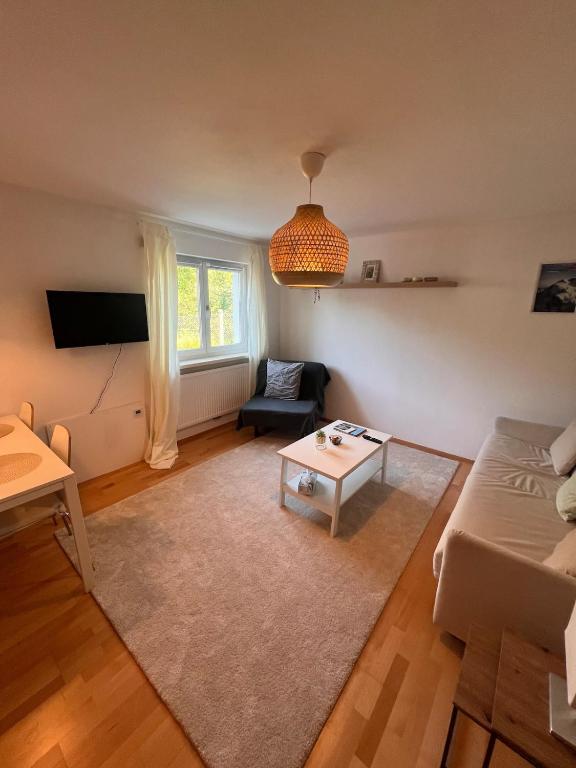 a living room with a couch and a table at Central Home in Salzburg