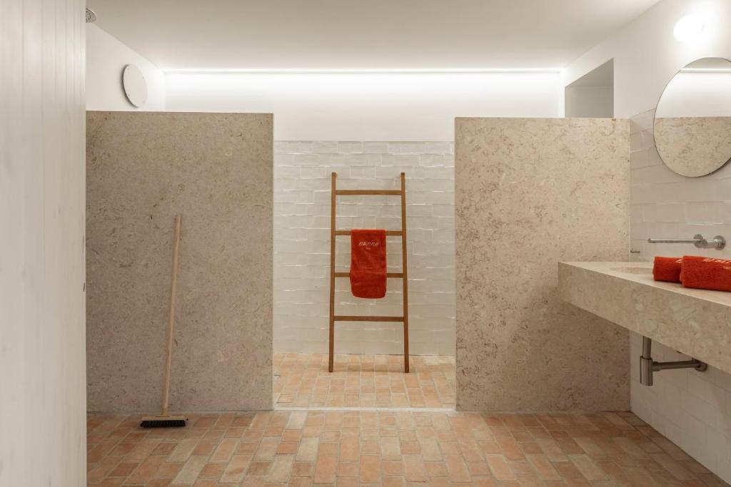 a bathroom with a red towel on a ladder at Danna Portuguese Design House Porta 11 in Tavira