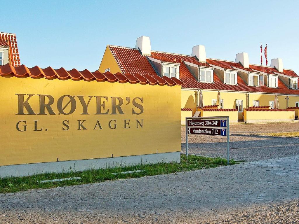 a yellow building with a sign that reads kroyers g stenger at 4 star holiday home in Skagen in Skagen