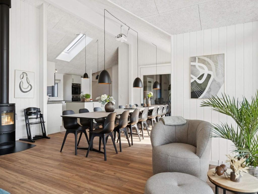 a dining room and kitchen with a table and chairs at 5 star holiday home in Bogense in Bogense