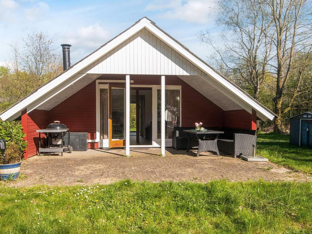 a small house with a grill in front of it at 6 person holiday home in Toftlund in Toftlund