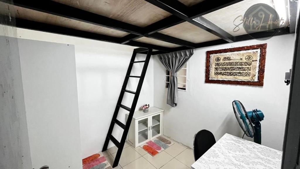 a room with a ladder and a white wall at Ss Homestay By Stella Ketiau,Putatan in Kota Kinabalu