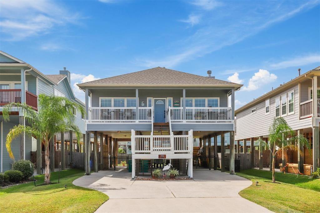 a large house with a white deck and a porch at Portofino House - Seabrook - 3 Bed 2 Bath Hot Tub in Seabrook