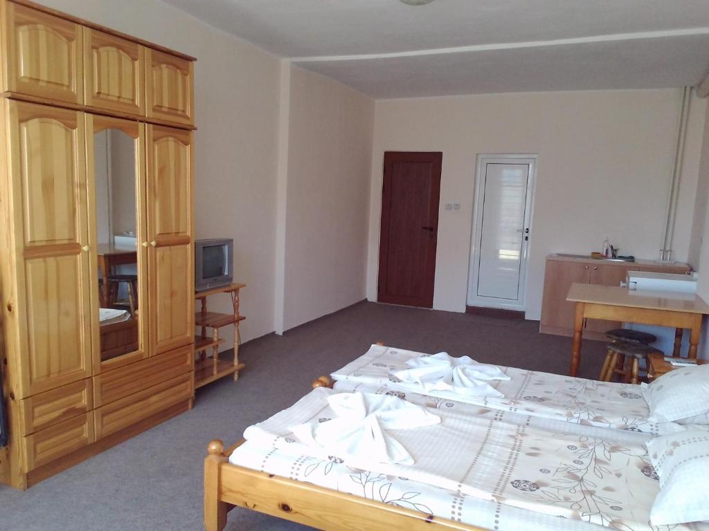 a bedroom with a bed and a cabinet and a desk at Guest House Diamant in Sozopol