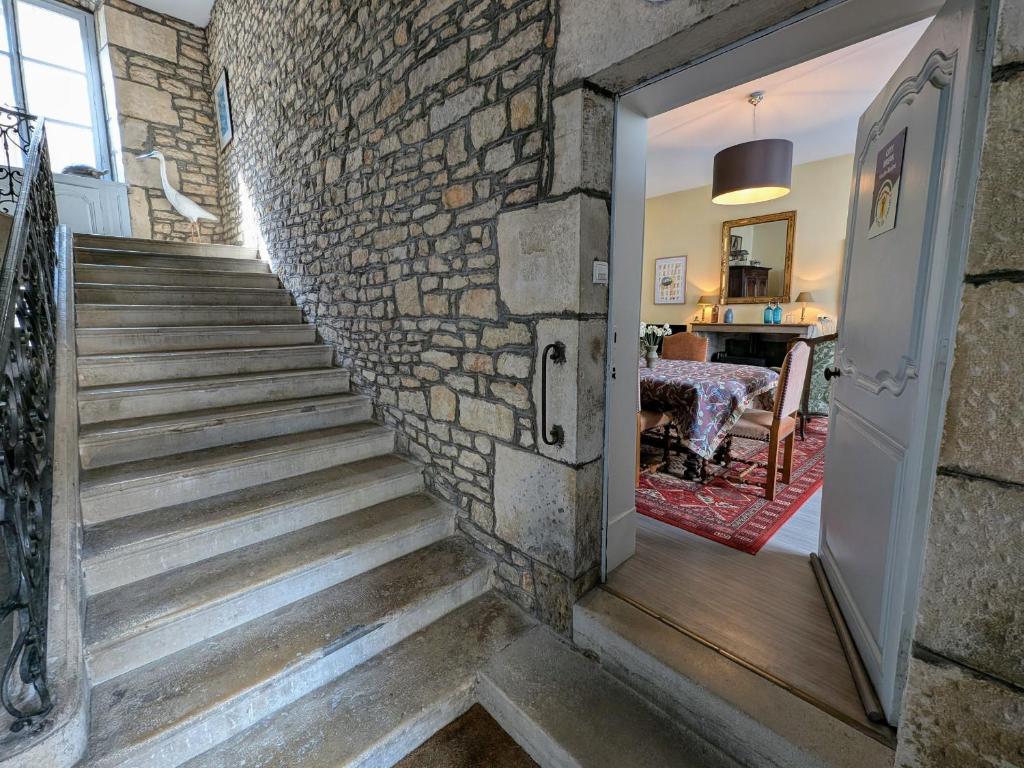 a stairway leading up to a brick wall at Charmant appartement historique à Vesoul, avec WIFI et parking - FR-1-583-508 in Vesoul
