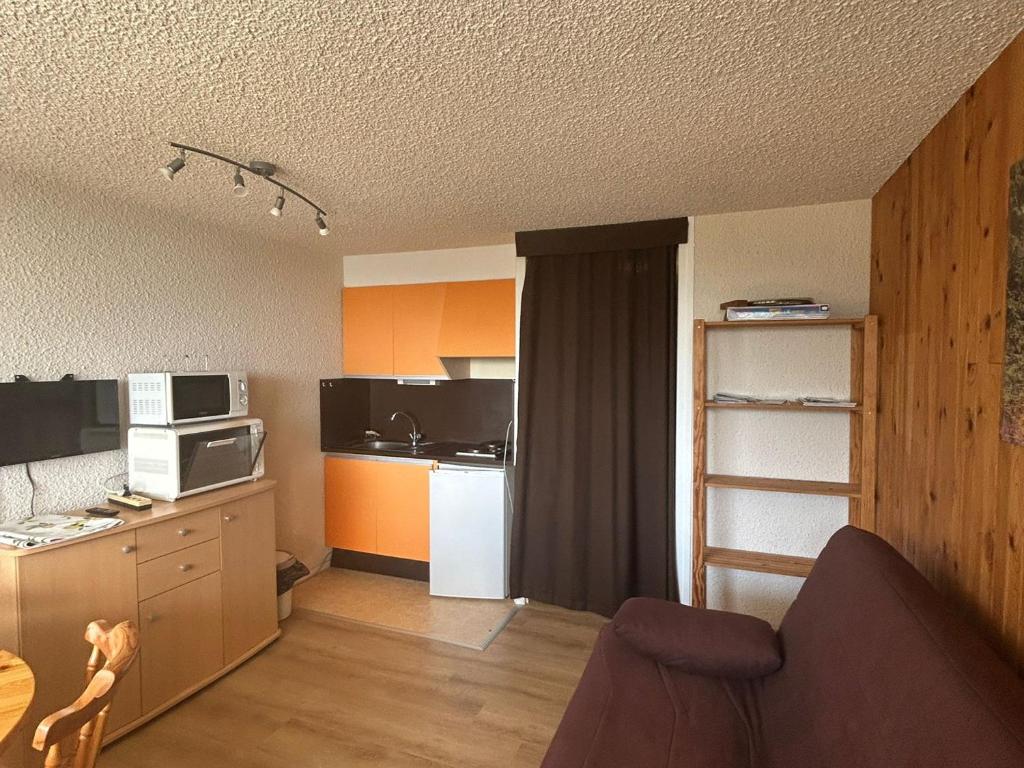 a room with a kitchen and a living room at Studio à Super Besse avec vue sur pistes et balcon - FR-1-814-16 in Besse-et-Saint-Anastaise