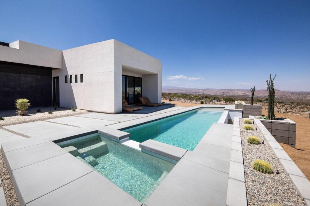 a villa with a swimming pool in the desert at White Casita by Fieldtrip - Modern w Pool Spa in Joshua Tree