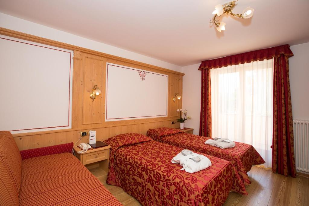 Postel nebo postele na pokoji v ubytování Hotel Cristina