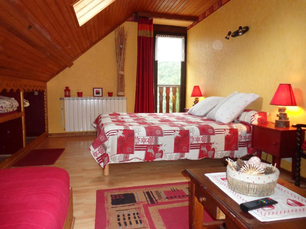 a large bedroom with two beds and a table at L'Arcouli in Sers