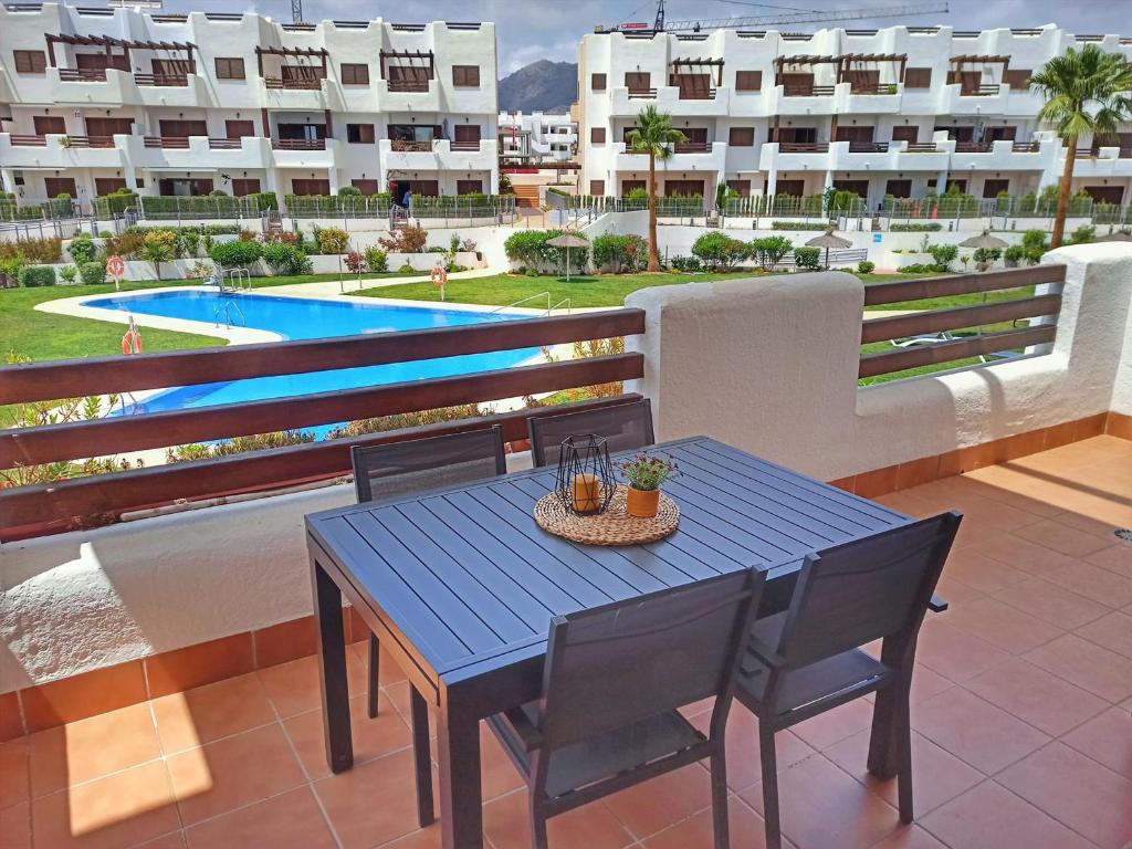 a blue table and chairs on the balcony of a apartment at Apartamento moderno con piscina, a 500m de la playa, San Juan de los Terreros - ES-376-41 in Pulpí