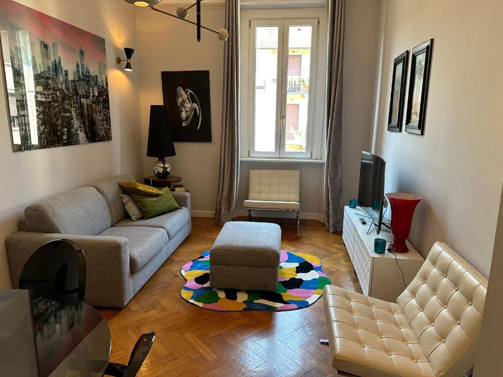 a living room with a couch and a chair at Elegant and beautiful apartment in Milan