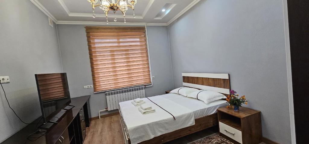 a small bedroom with a bed and a window at PrestigeVilla in Akchiy
