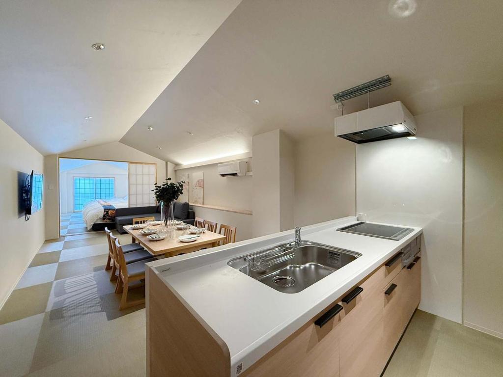 a kitchen with a sink and a dining room at b hotel Miyajima Omotesando - Sacred Island Stay 31 in Miyajima