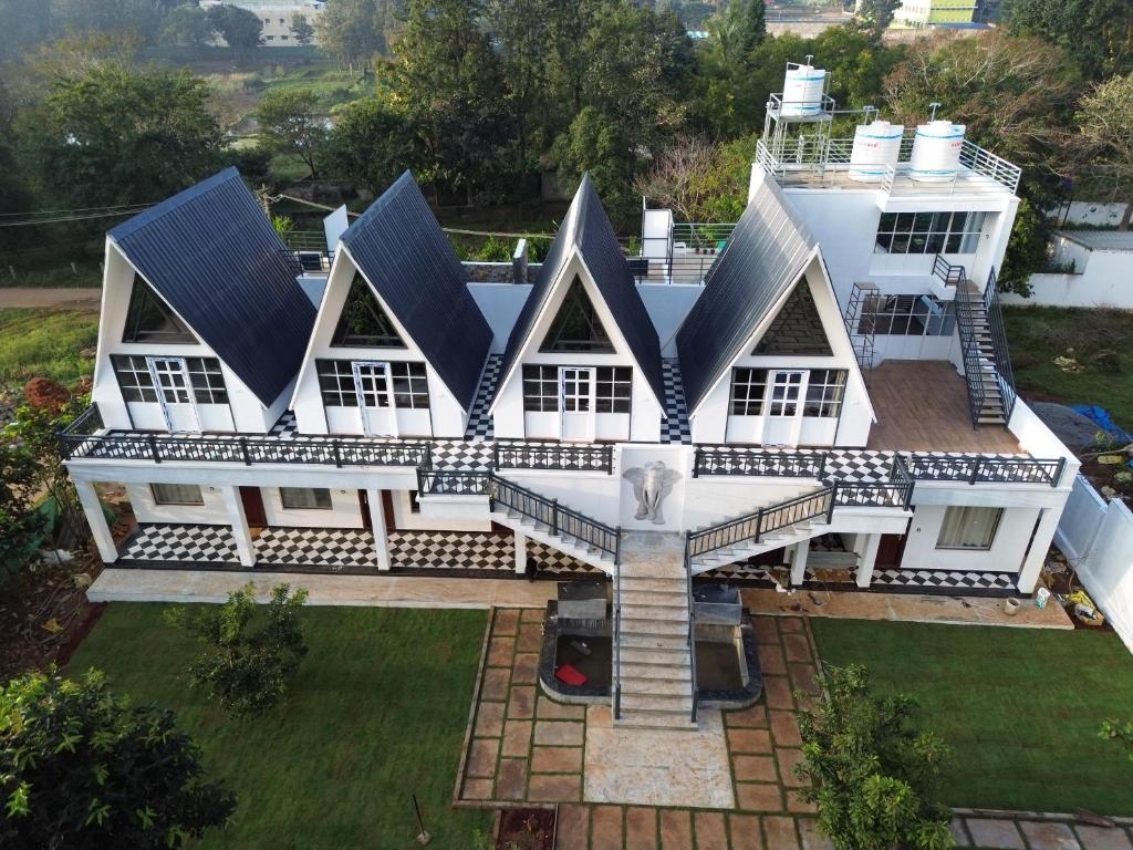 an aerial view of a house with solar panels on the roof at The Novel Holiday Resorts in Yelagiri