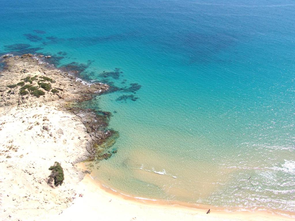 an aerial view of a beach and the ocean at Sa Tirìa in Chia