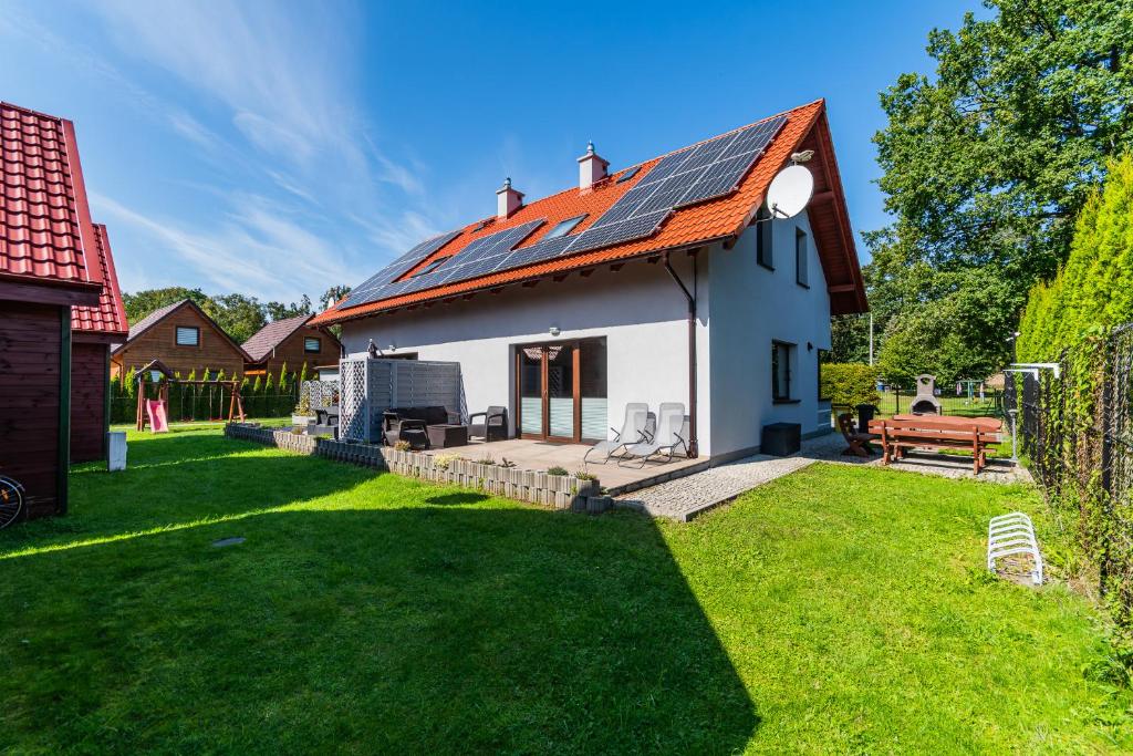 a house with solar panels on the roof at Willa Słoneczna in Sztutowo