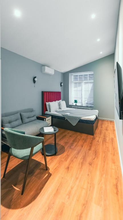 a living room with a bed and a couch at Capital City Hotel in Baku