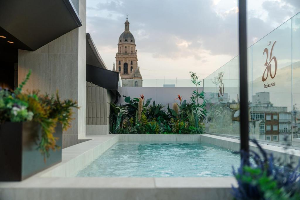 a swimming pool on the roof of a building at Los 36 by GRUPO CCOMMO in Murcia
