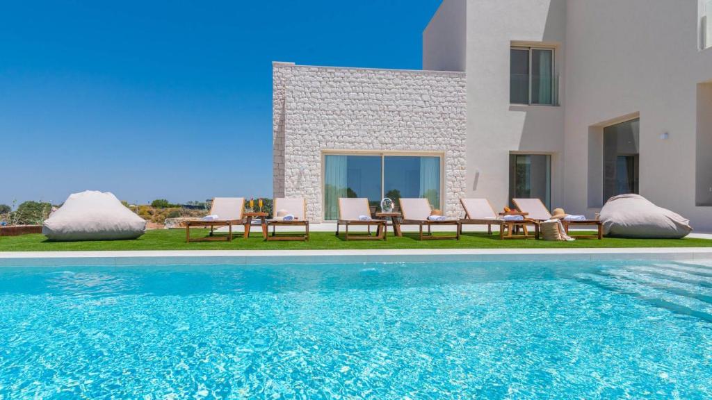 a villa with a swimming pool next to a house at Villa Selena Antequera by Ruralidays in Antequera