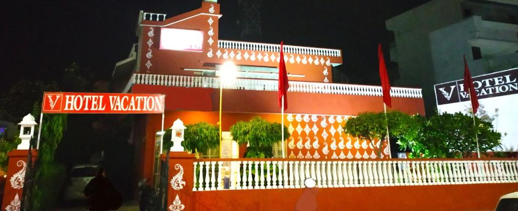 an orange building with street signs in front of it at Hotel Vacation in Jaipur
