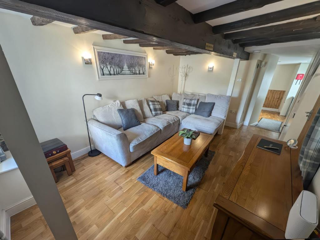 a living room with a couch and a table at Hocking Cottage in Torquay