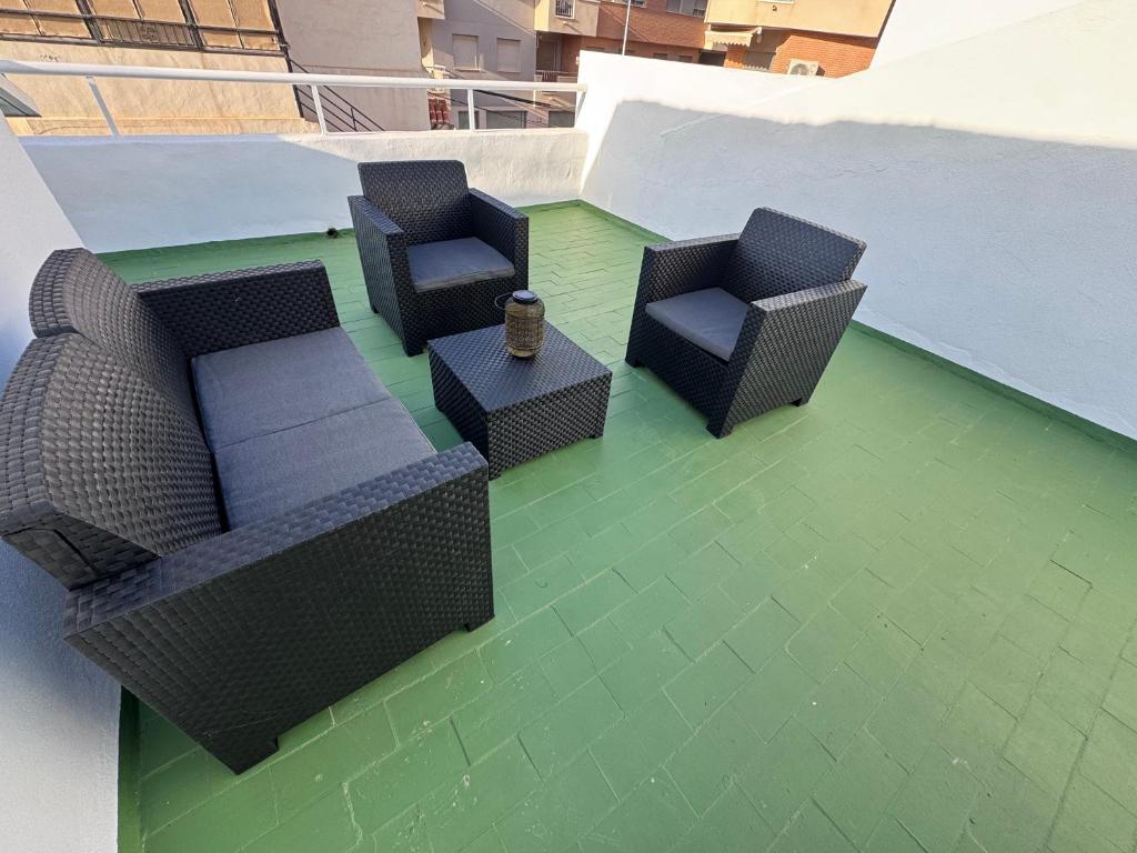 a patio with two chairs and a table on a roof at Alma azul in Puerto de Mazarrón