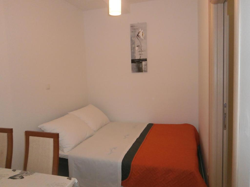 Postel nebo postele na pokoji v ubytování Apartmani Perak