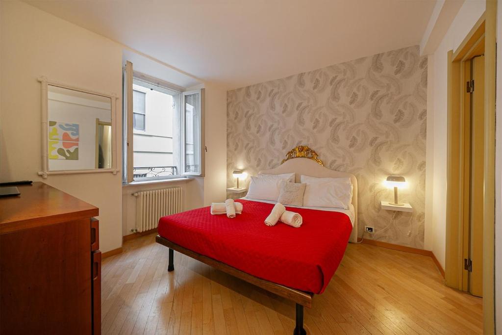 ein Schlafzimmer mit einem roten Bett mit zwei Kissen in der Unterkunft Borgo 19 - Centro Como in Como