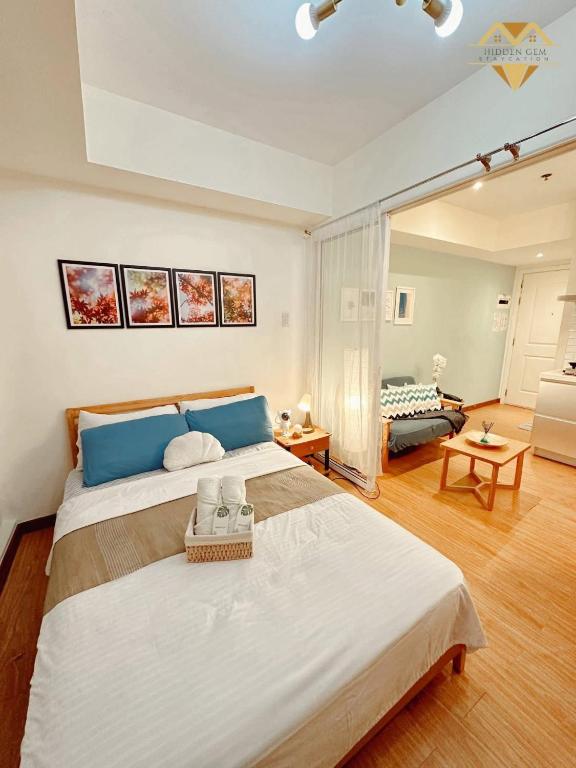 a large bedroom with a large bed and a living room at Havenscape Staycation in Manila