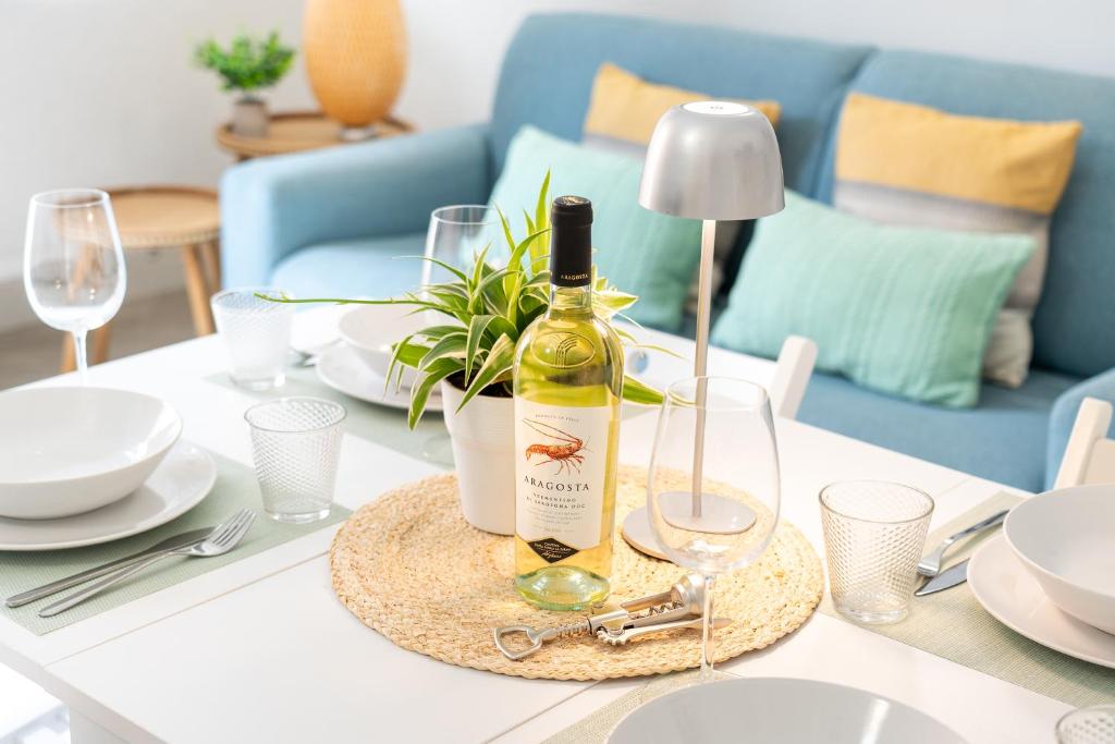 a bottle of wine sitting on top of a table at Cozy 1 BDR - Downtown Milan Navigli, Duomo in Milan