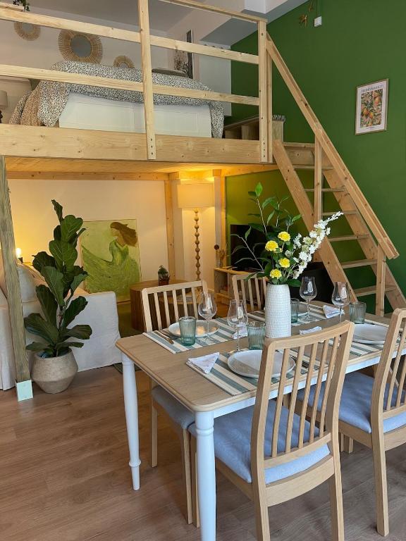a dining room with a table and chairs and a bunk bed at Le nid d'Ambre in Étaples