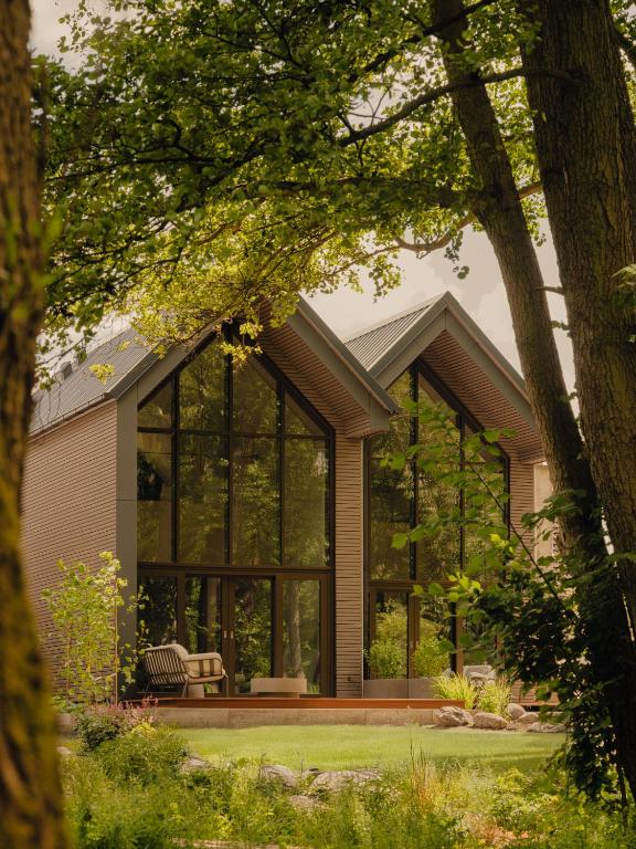a house with a large window on the side of it at Green View Tornow in Fürstenberg