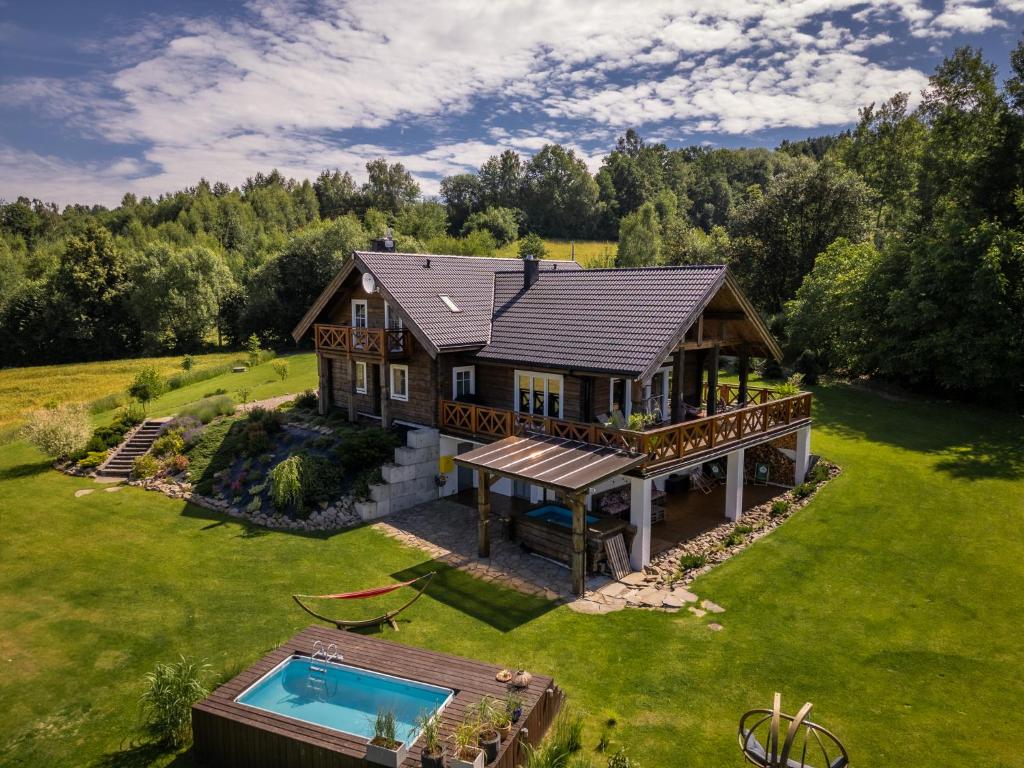 an aerial view of a house with a swimming pool at CHATA POD PRZEHYBĄ in Stary Sącz