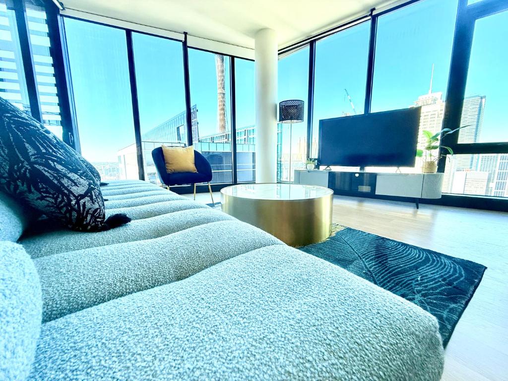 a room with four beds and a television in a building at Sydney CBD Top level 2 bedroom Condo with amazing view Pool Gym 3 in Sydney
