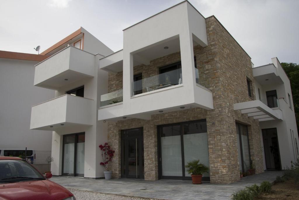 a modern house with white at Apartments Brežanin in Sutomore