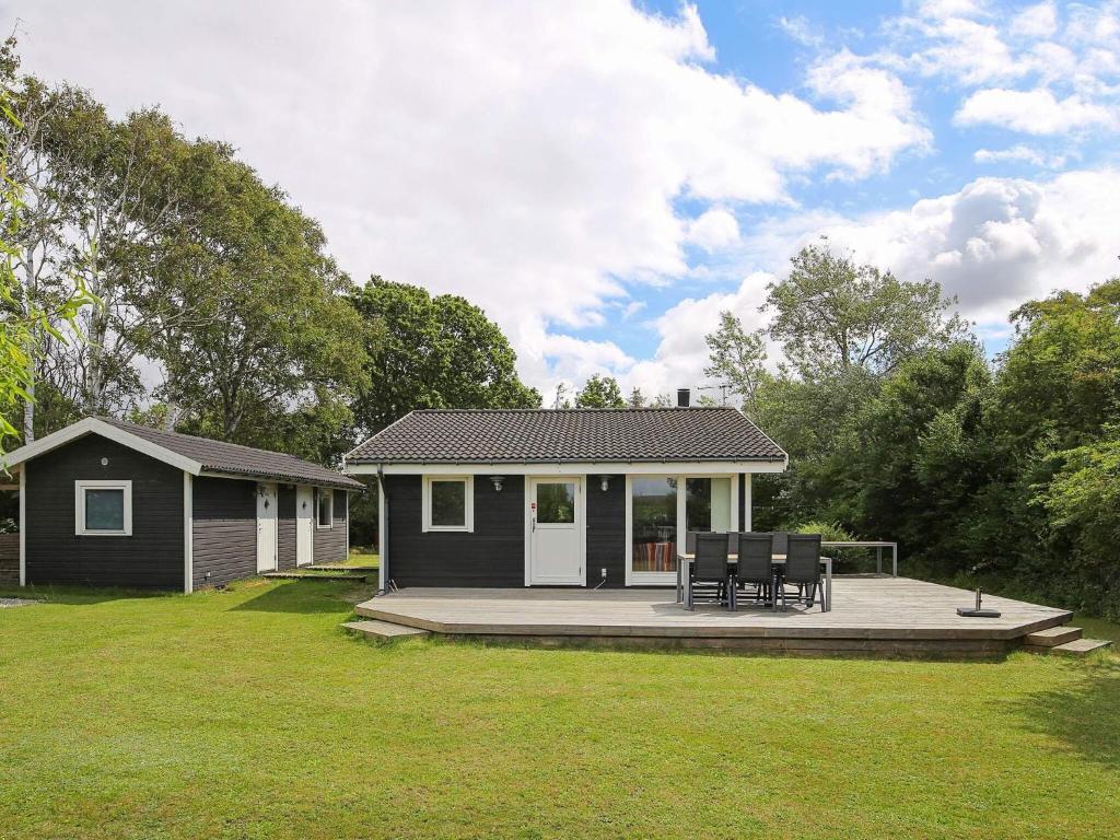 a small house with two chairs on a patio at 6 person holiday home in Slagelse in Slagelse