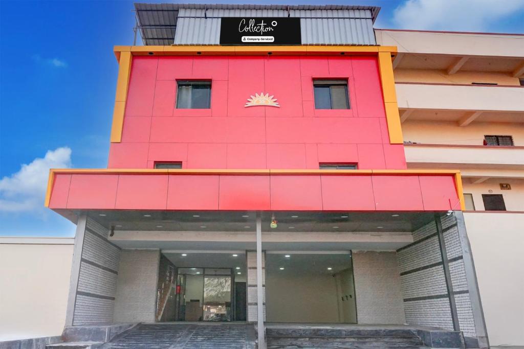 a red building with a sign on it at Collection O Talwade in Pune