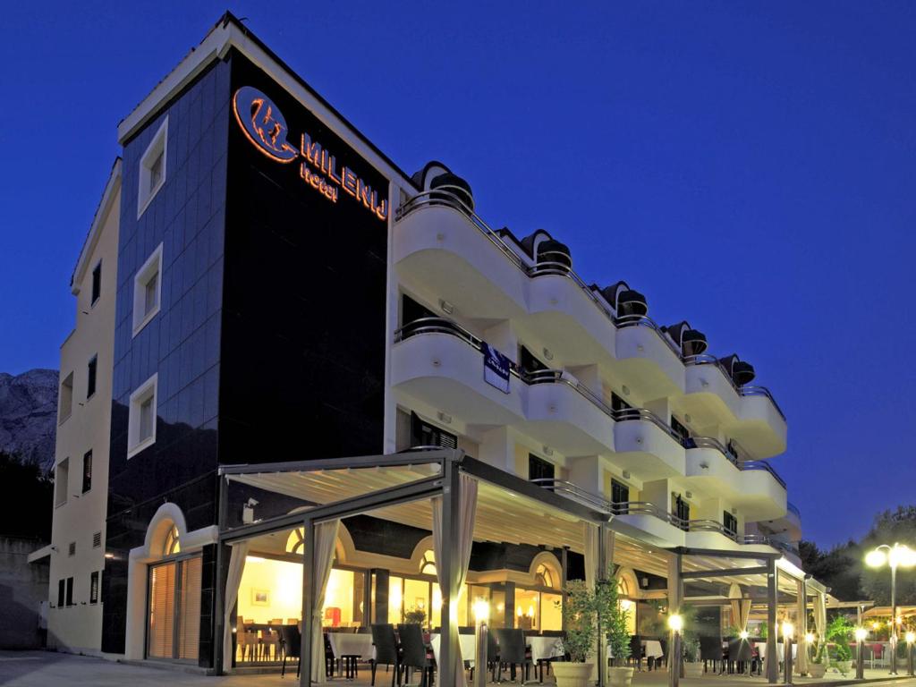 a building with a sign on the side of it at Hotel Milenij in Makarska