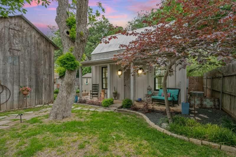 a small white house with a fence at Remmler Nest Hot-Tub Prime Location 3-Blks to Main! in Fredericksburg