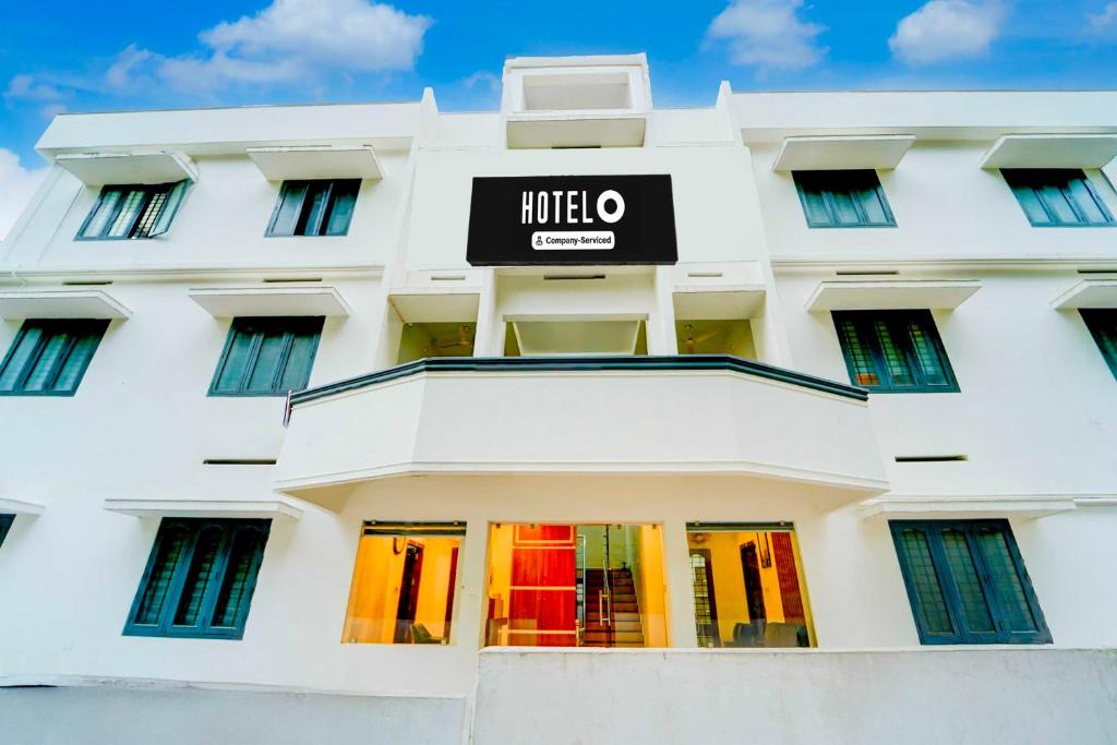 a white building with a hotel sign on it at Super Hotel O Kazhakootam Near Technopark Phase 2 in Trivandrum