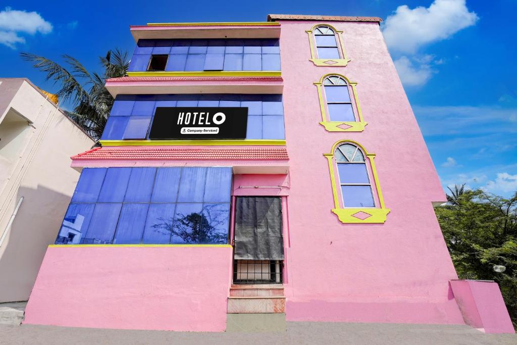 a pink building with a mitto sign on it at Hotel O Nemeli Road Sriram Nagar in Chennai