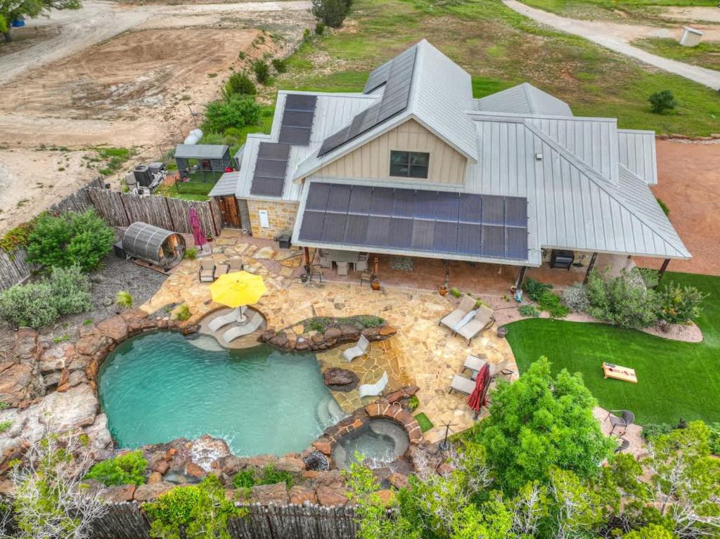 an aerial view of a house with a swimming pool at West End Lodge Resort Style Pool! in Fredericksburg