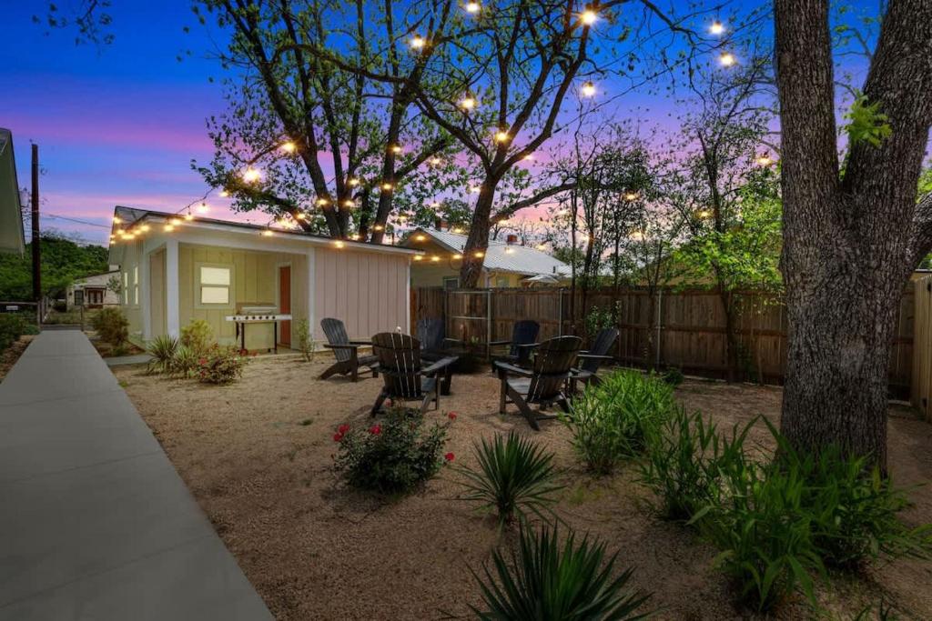 a backyard with a house with lights on it at The Grove-C with Hot Tub - Walk to Main Street in Fredericksburg
