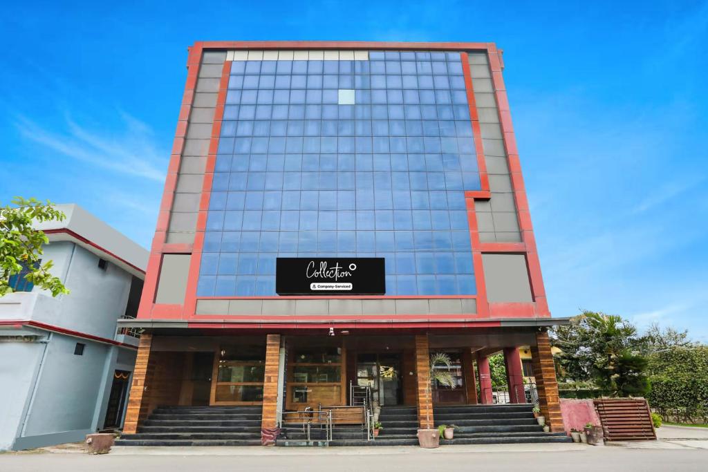 a building with a sign on the side of it at Collection O Tikonia Formerly Hotel Jatin in Haldwāni