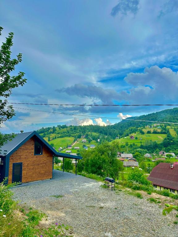a building on the side of a hill with a bench at Veranda Rozhanka in Verkhnyaya Rozhanka